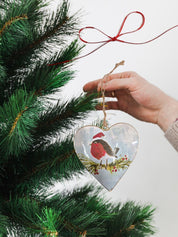 Tin heart-shaped Christmas decoration depicting a delightful robin wearing a Santa hat, ideal for bringing joyful holiday accents.