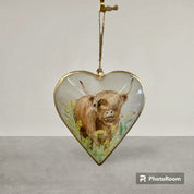 Elegant hanging tin decoration showcasing a flowery design of a Highland cow, perfect as a distinctive holiday ornament.