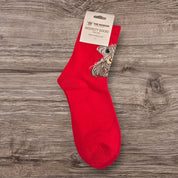 Pair of McMoo Highland Cow Socks in vibrant red, showcasing a detailed Highland cow paintbrush design by Jennifer Hogwood.