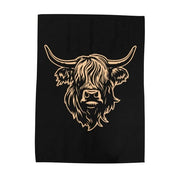 A black cotton tea towel showcasing a gold-foil style silhouette of a Highland cow head.